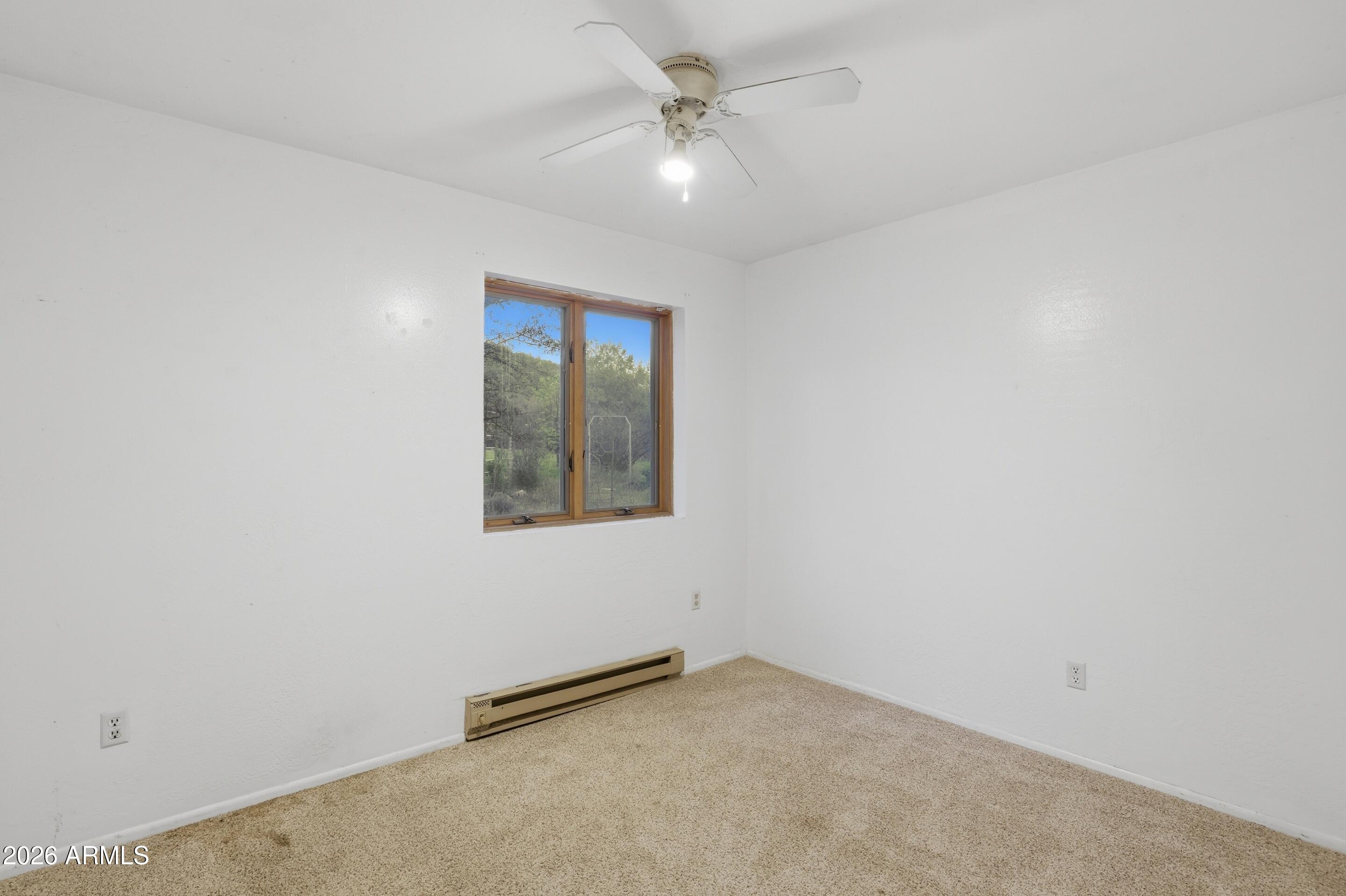 8135 West Gibson Ranch Road Payson, AZ 85541 - Photo 16 of 43 an empty room with a fan & a ceiling fan