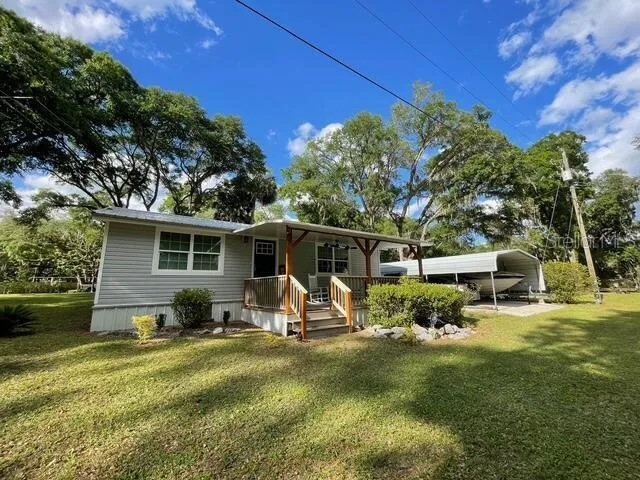 a view of a house with backyard