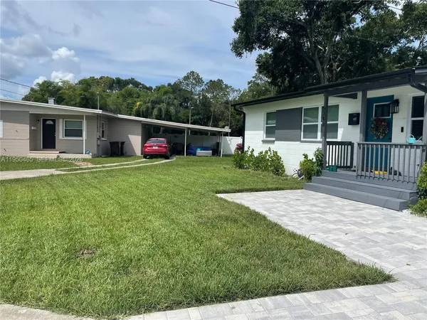 a view of a house with a yard and a garden