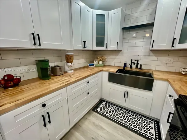 a kitchen with a sink and cabinets