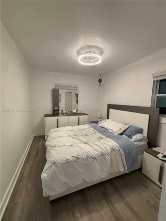 a bedroom with a bed and a night stand