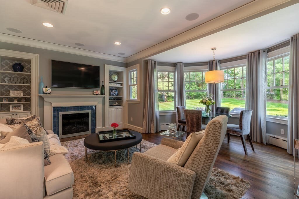 6 Hampton Road Lexington, MA 02421 - Photo 12 of 41 a living room with furniture a flat screen tv and a fireplace