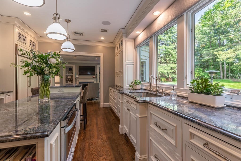 6 Hampton Road Lexington, MA 02421 - Photo 15 of 41 a kitchen with kitchen island granite countertop counter space a sink appliances and a large window