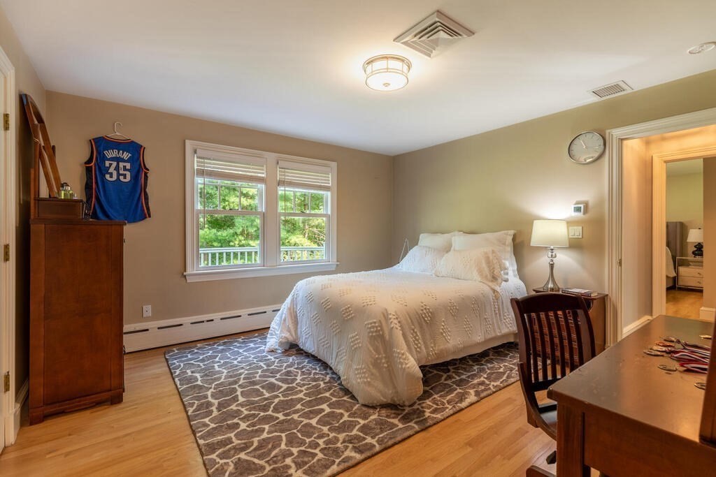 6 Hampton Road Lexington, MA 02421 - Photo 27 of 41 a bedroom with a bed and wooden floor
