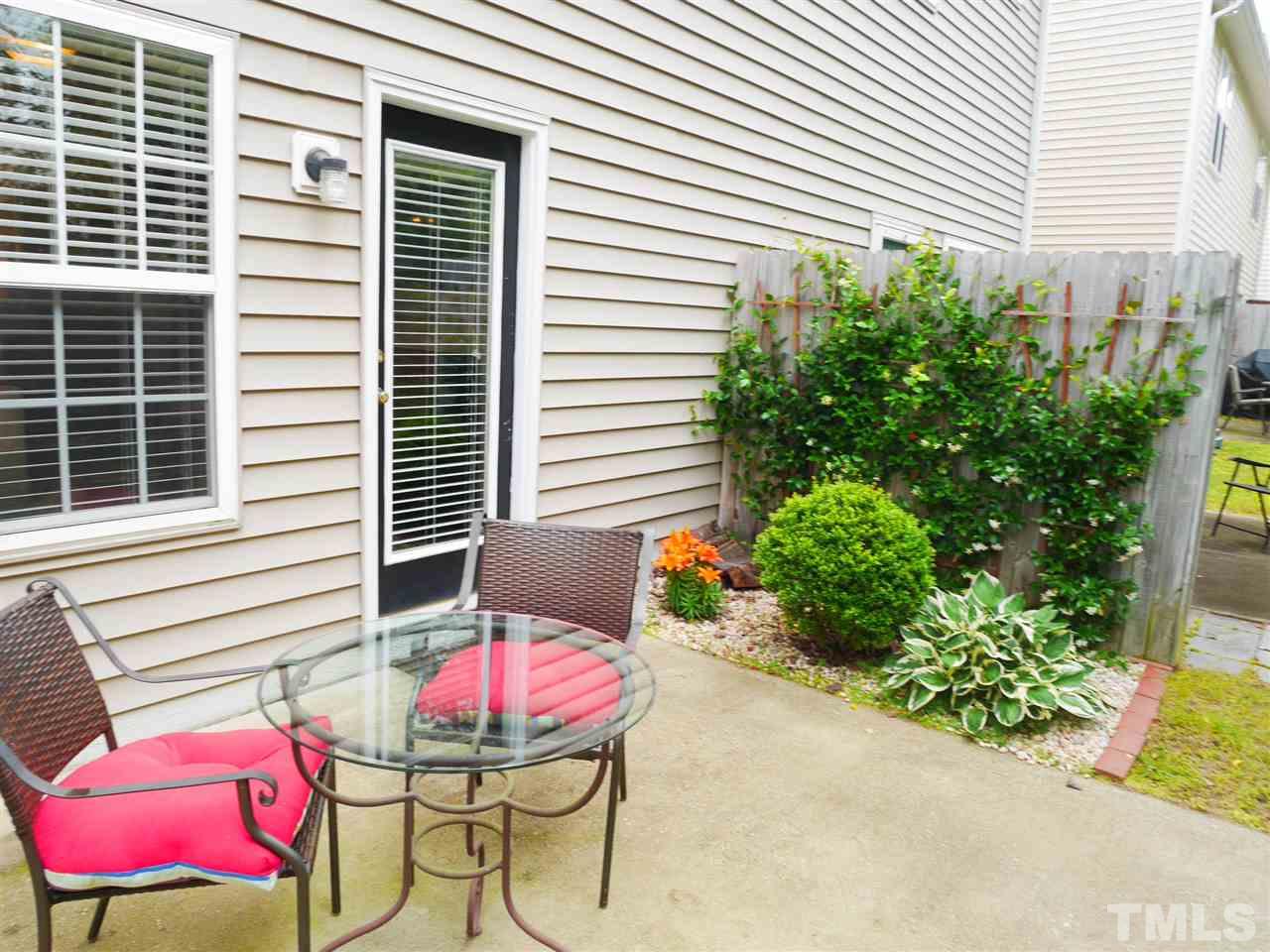 2016 Metacomet Way Raleigh, NC 27604 - Photo 2 of 24 a view of a patio with a table and chairs and potted plants