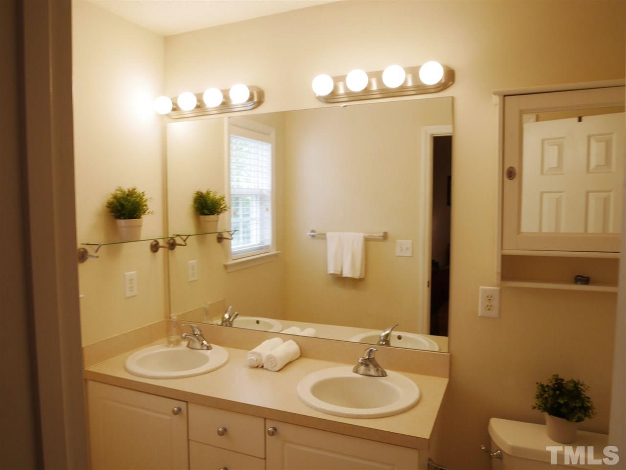 2016 Metacomet Way Raleigh, NC 27604 - Photo 12 of 24 a bathroom with a sink and a mirror
