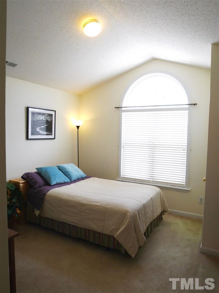 2016 Metacomet Way Raleigh, NC 27604 - Photo 16 of 24 a bedroom with a bed and a window