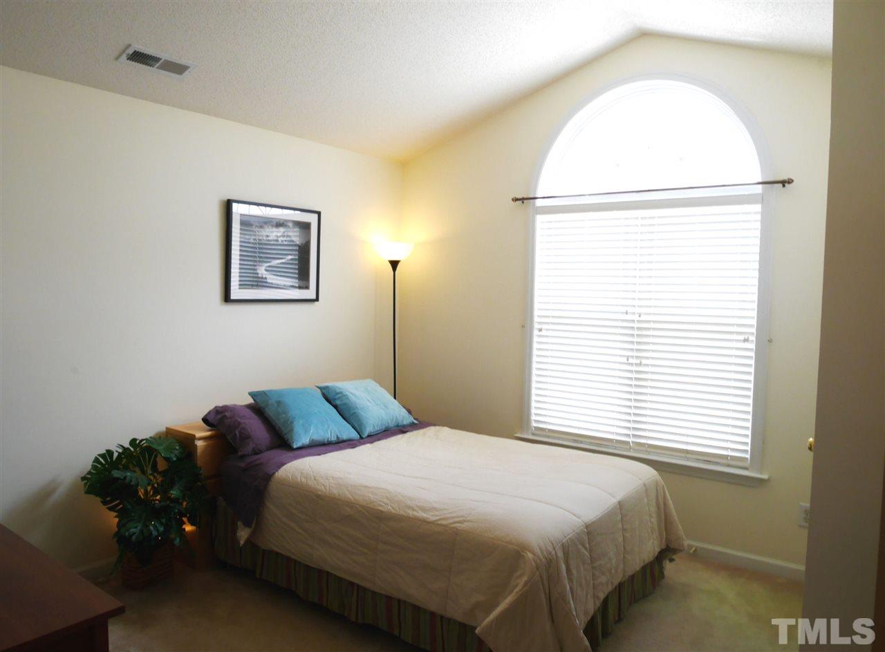 2016 Metacomet Way Raleigh, NC 27604 - Photo 18 of 24 a bedroom with a bed and a window