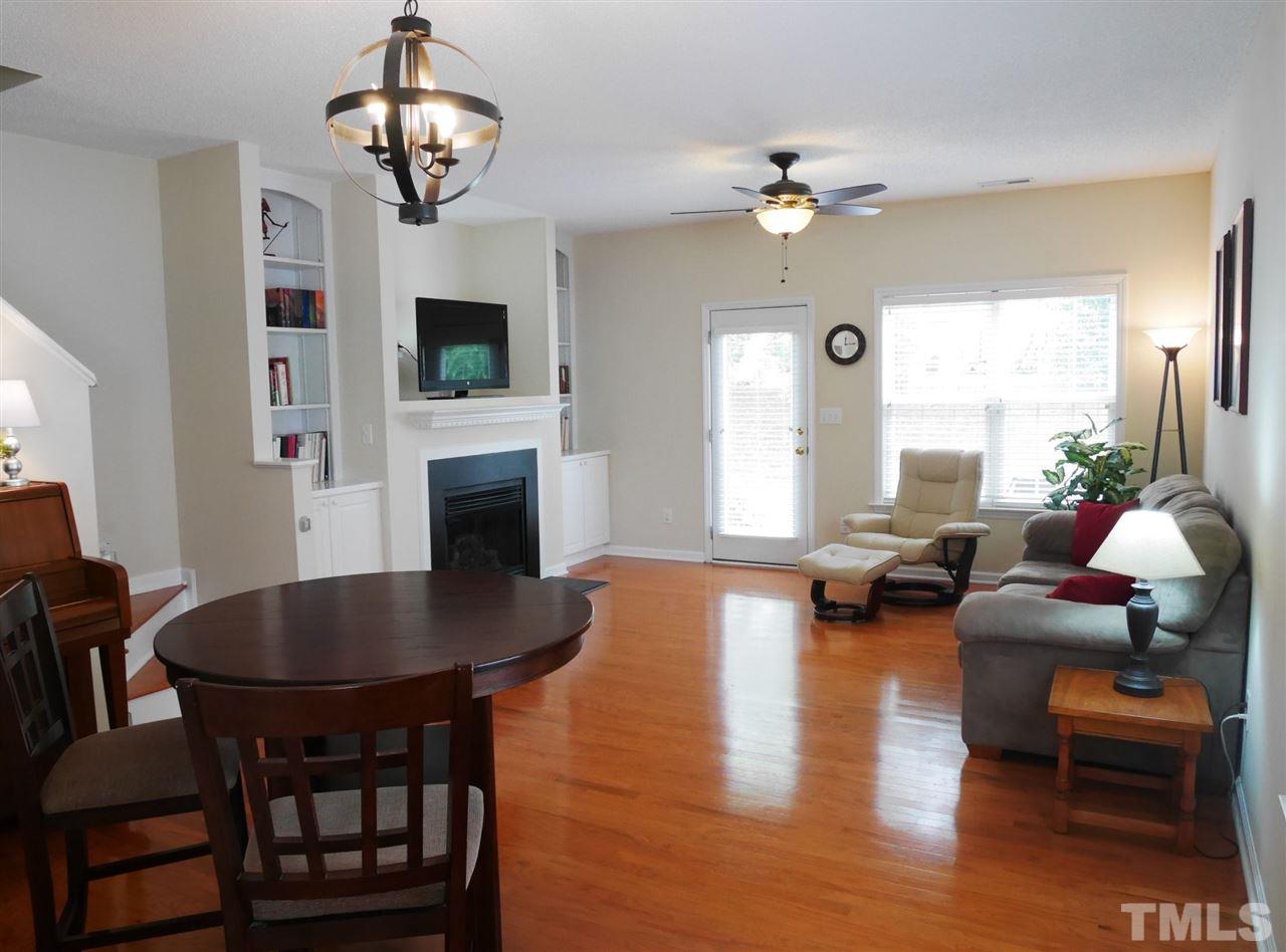 2016 Metacomet Way Raleigh, NC 27604 - Photo 3 of 24 a living room with fireplace a dining table and a fireplace