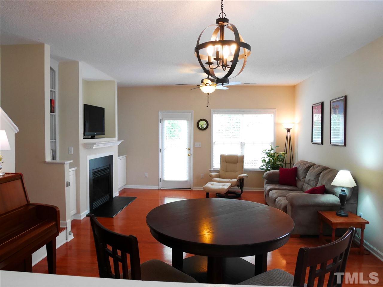 2016 Metacomet Way Raleigh, NC 27604 - Photo 7 of 24 a living room with fireplace furniture and a chandelier