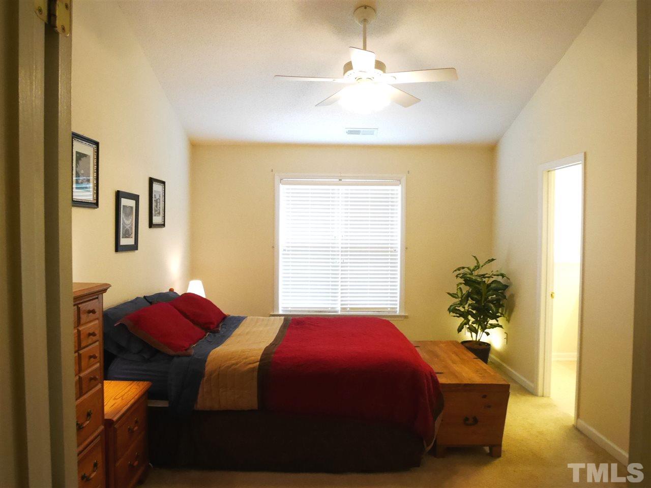 2016 Metacomet Way Raleigh, NC 27604 - Photo 10 of 24 a bedroom with a bed and a chandelier