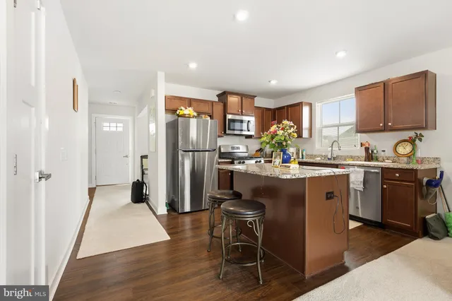 a bedroom with a bed dresser and a window