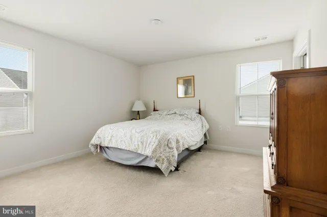 a bathroom with a toilet sink vanity and mirror