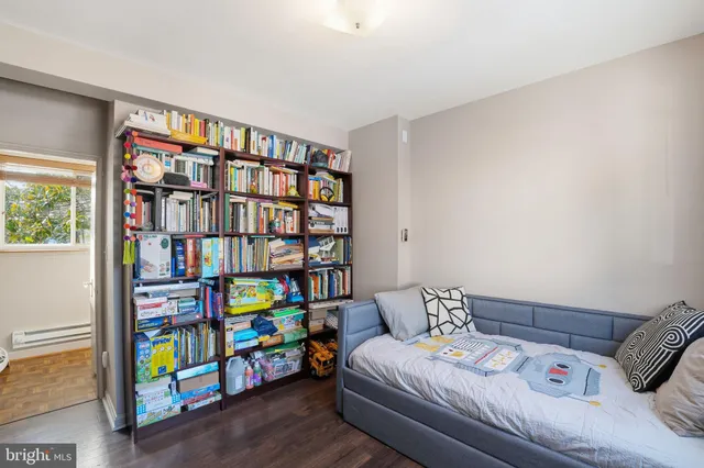 a bedroom with a bed and a book shelf