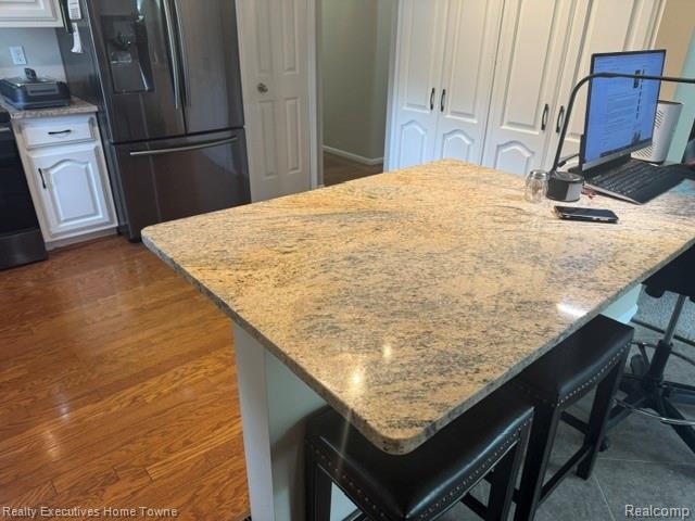 1467 Krafft Road, Unit 8 Port Huron, MI 48060 - Photo 10 of 28 Kitchen island featuring a stone countertop with rounded edges