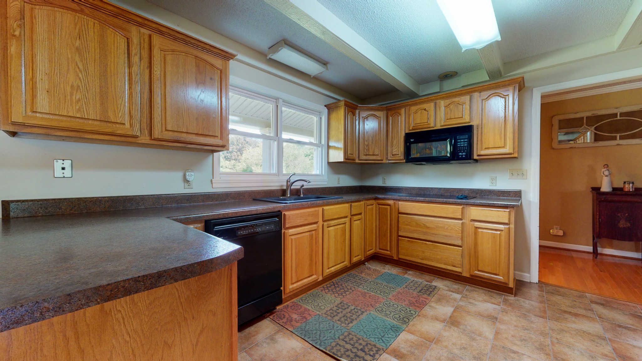 4741 Cathey Ridge Road Manchester, TN 37355 - Photo 25 of 50 a kitchen with stainless steel appliances granite countertop a stove a sink and a microwave