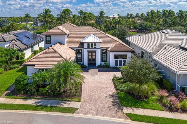 a aerial view of a house with a yard and potted plants