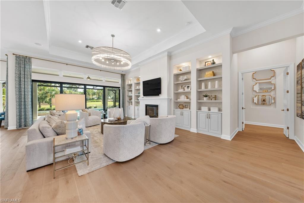 15266 Arpino Court Naples, FL 34114 - Photo 11 of 48 a living room with furniture and a flat screen tv