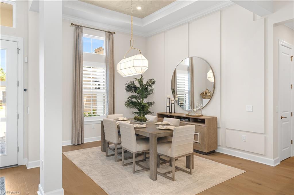 15266 Arpino Court Naples, FL 34114 - Photo 12 of 48 a view of a dining room with furniture and wooden floor