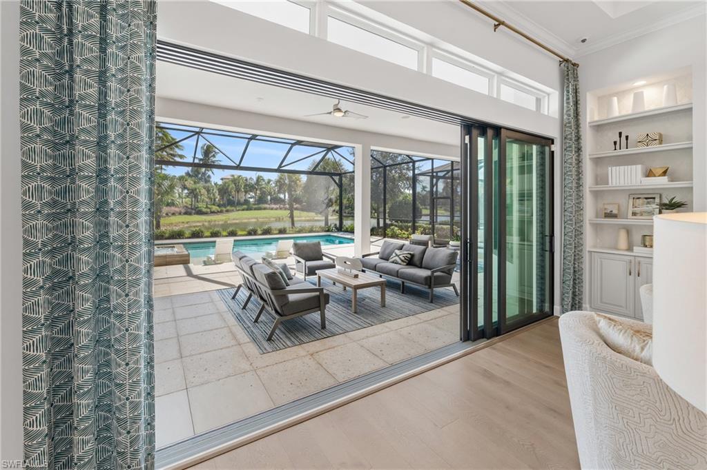15266 Arpino Court Naples, FL 34114 - Photo 13 of 48 a living room with furniture and a large window