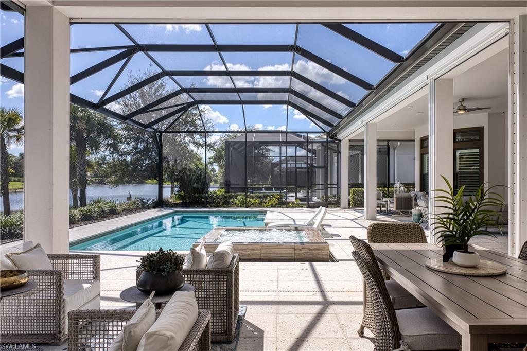 15266 Arpino Court Naples, FL 34114 - Photo 14 of 48 a living room with furniture and a large window