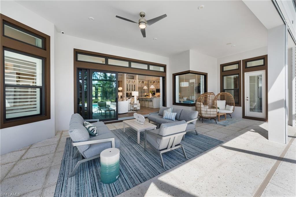 15266 Arpino Court Naples, FL 34114 - Photo 15 of 48 a living room with furniture and a large window