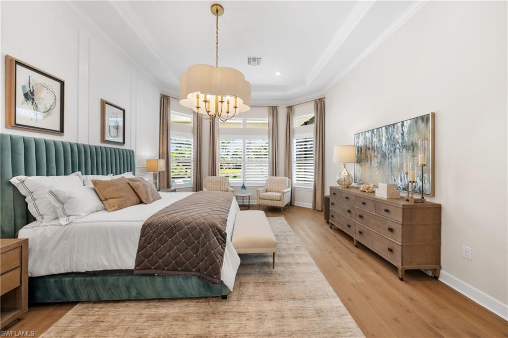 15266 Arpino Court Naples, FL 34114 - Photo 16 of 48 a spacious bedroom with a bed and large windows