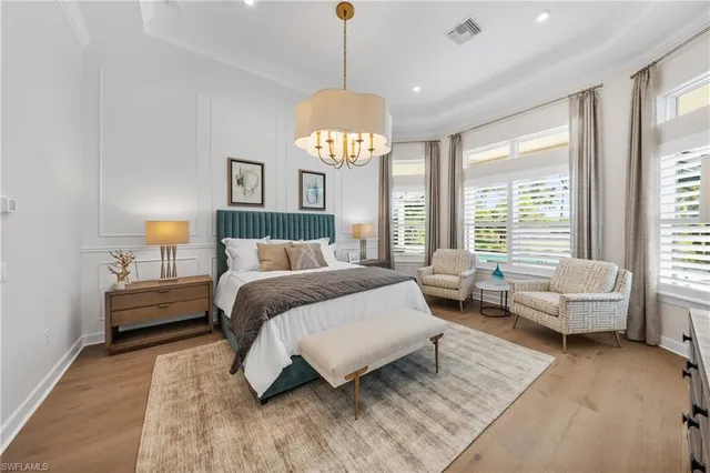 a spacious bedroom with a bed and large windows