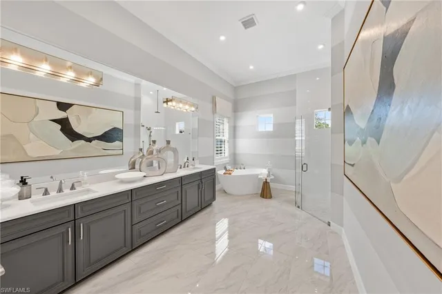 a spacious bedroom with a bed and a chandelier