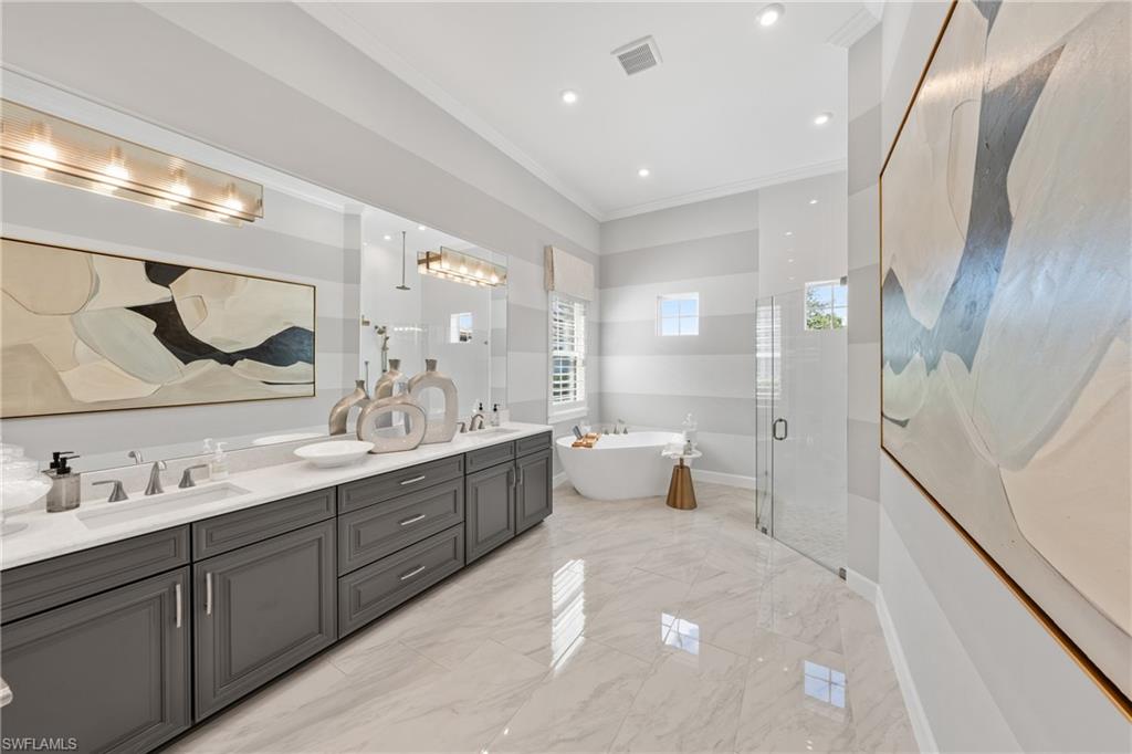 15266 Arpino Court Naples, FL 34114 - Photo 18 of 48 a spacious bathroom with a double vanity sink a mirror and a shower