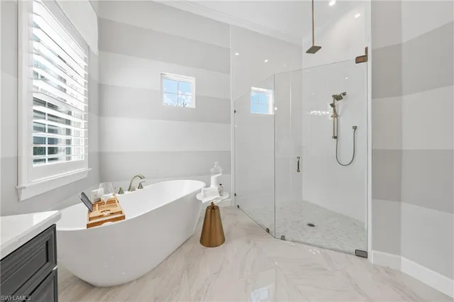 a spacious bathroom with a double vanity sink a mirror and a shower