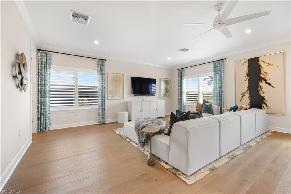 15266 Arpino Court Naples, FL 34114 - Photo 26 of 48 a living room with furniture and a flat screen tv