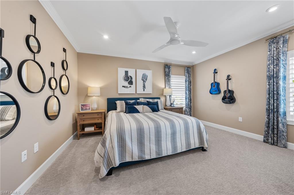 15266 Arpino Court Naples, FL 34114 - Photo 29 of 48 a spacious bedroom with a bed and a chandelier