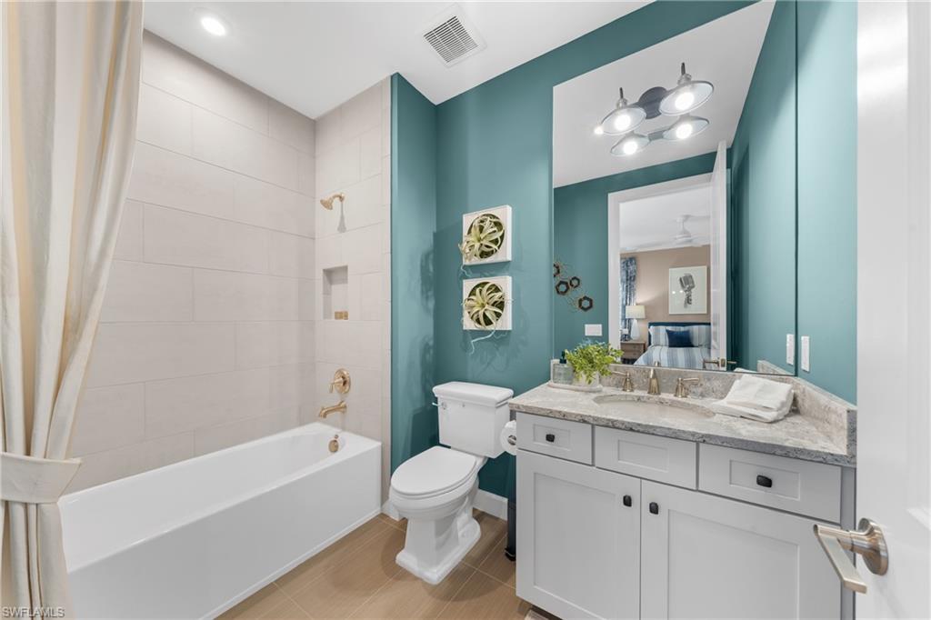 15266 Arpino Court Naples, FL 34114 - Photo 30 of 48 a bathroom with a double vanity sink mirror and toilet