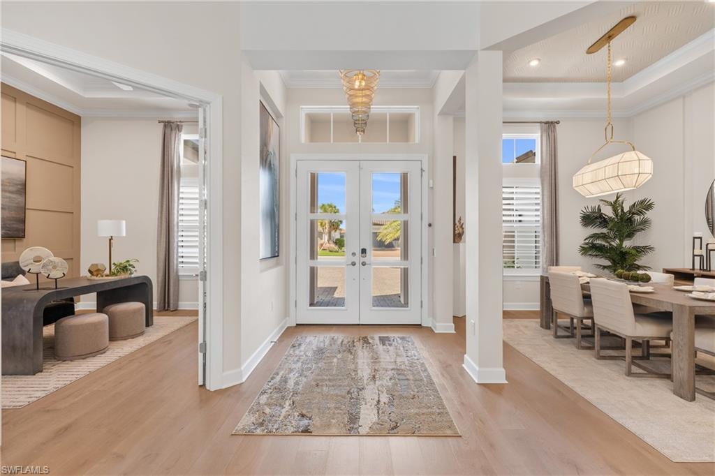 15266 Arpino Court Naples, FL 34114 - Photo 33 of 48 a living room with furniture and a chandelier