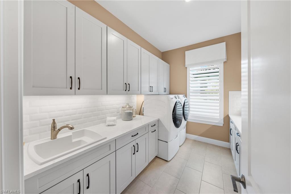 15266 Arpino Court Naples, FL 34114 - Photo 36 of 48 a utility room with a sink washer and dryer