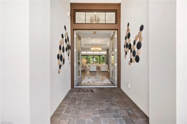 a view of a hallway with wooden floor and a hallway