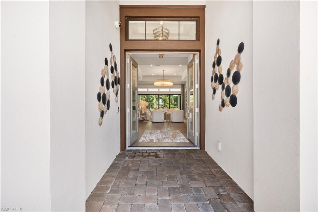 15266 Arpino Court Naples, FL 34114 - Photo 4 of 48 a view of a hallway with wooden floor and a hallway
