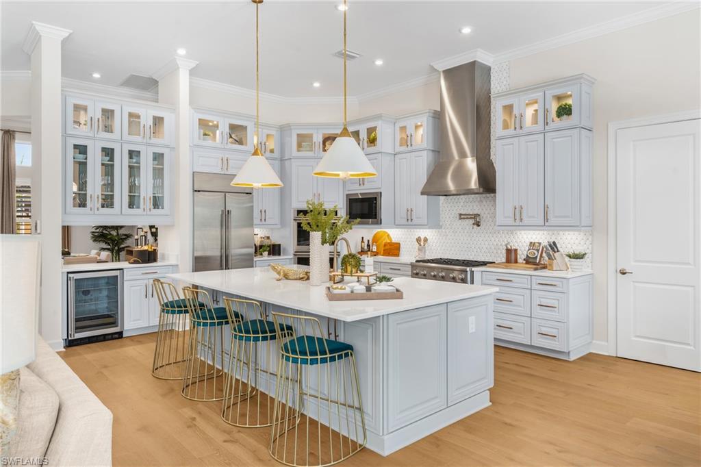15266 Arpino Court Naples, FL 34114 - Photo 5 of 48 a kitchen with stainless steel appliances granite countertop a sink stove and refrigerator