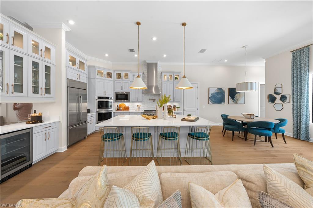 15266 Arpino Court Naples, FL 34114 - Photo 7 of 48 a large kitchen with a table and chairs