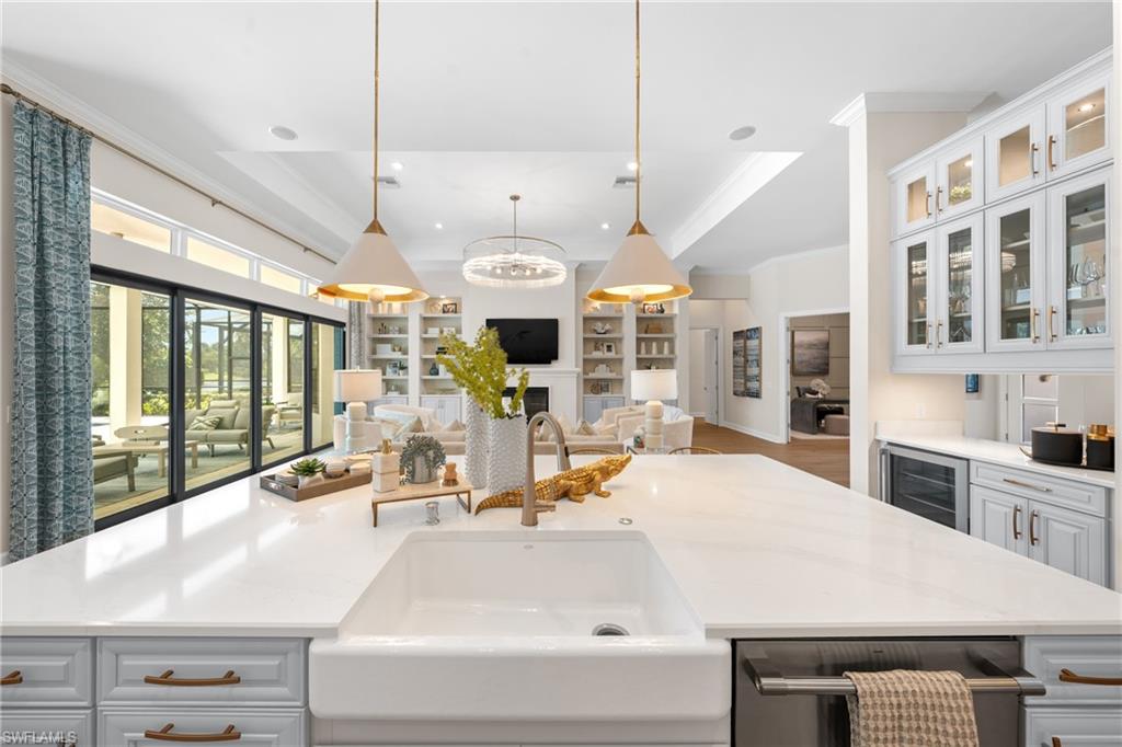 15266 Arpino Court Naples, FL 34114 - Photo 48 of 48 a large white kitchen with a large window and stainless steel appliances