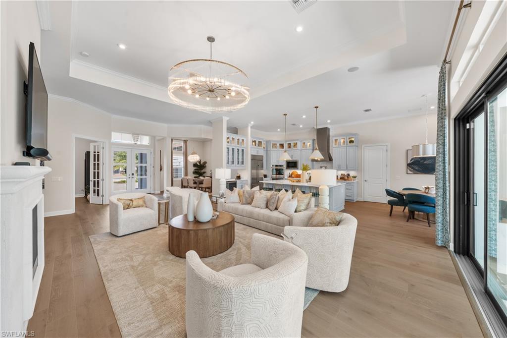 15266 Arpino Court Naples, FL 34114 - Photo 9 of 48 a living room with furniture kitchen view and a large window