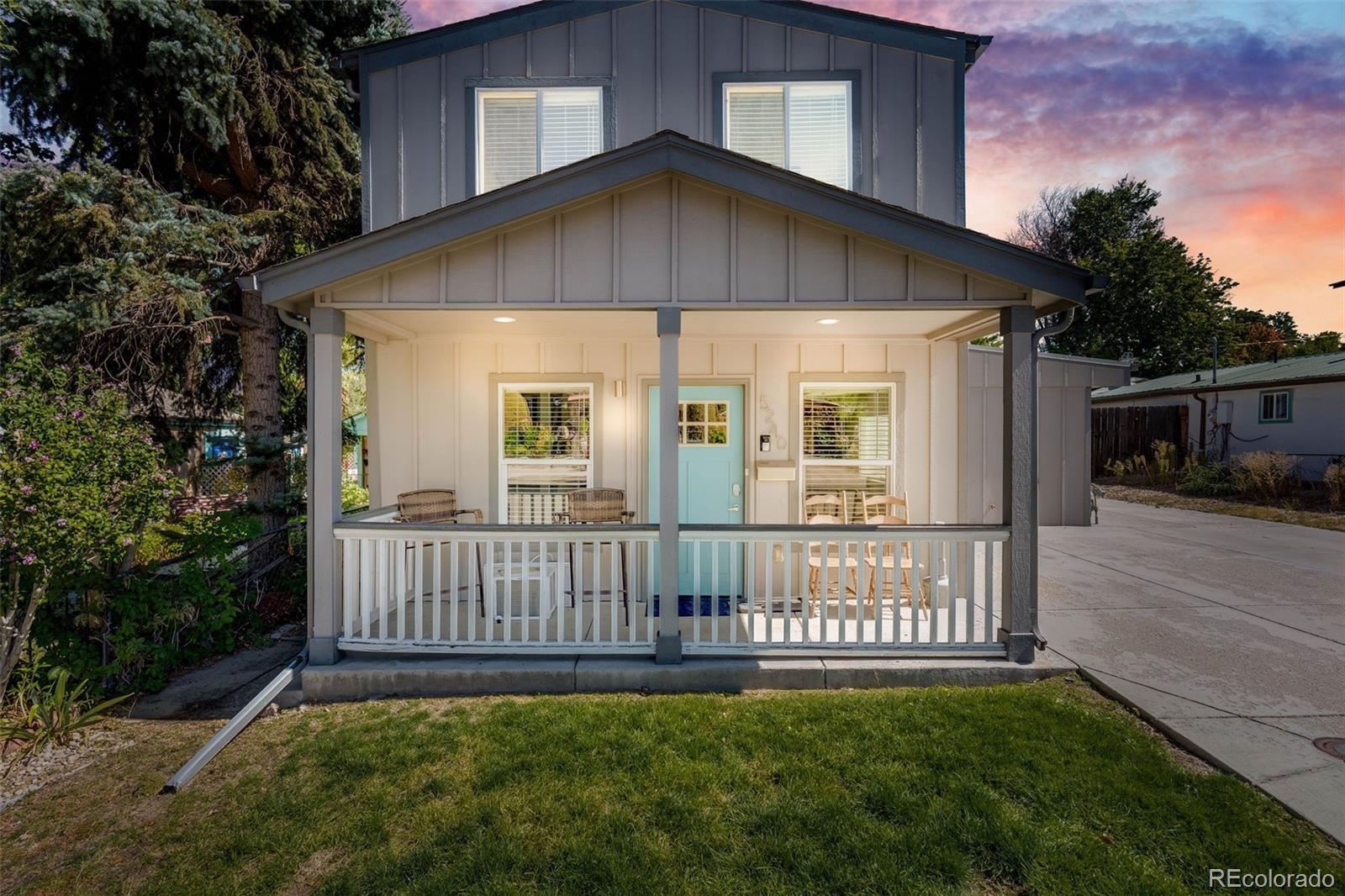 a view of a house with a yard and porch