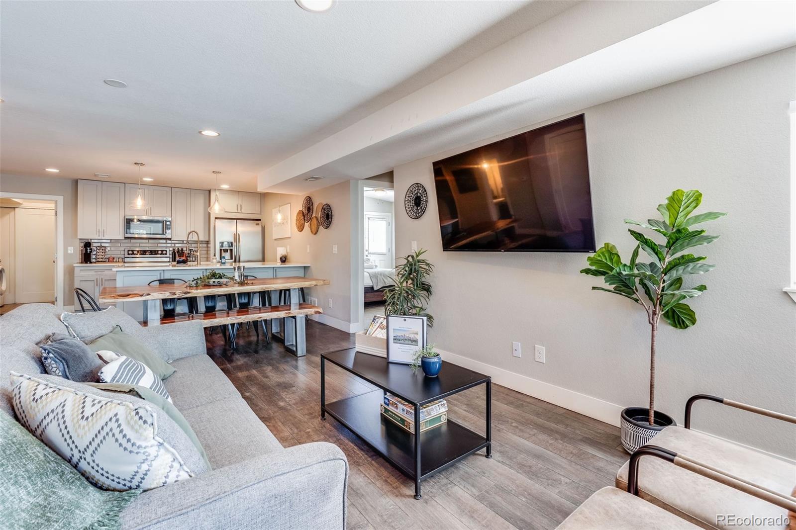 5240 Stuart Street Denver, CO 80212 - Photo 11 of 42 a living room with furniture potted plant and a flat screen tv