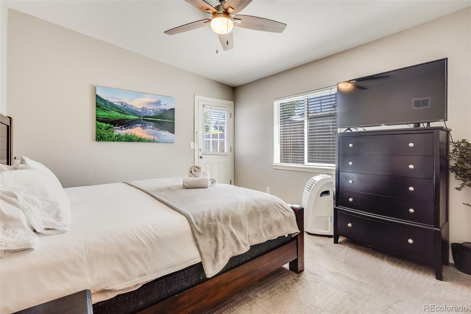5240 Stuart Street Denver, CO 80212 - Photo 15 of 42 a bedroom with a bed and a ceiling fan