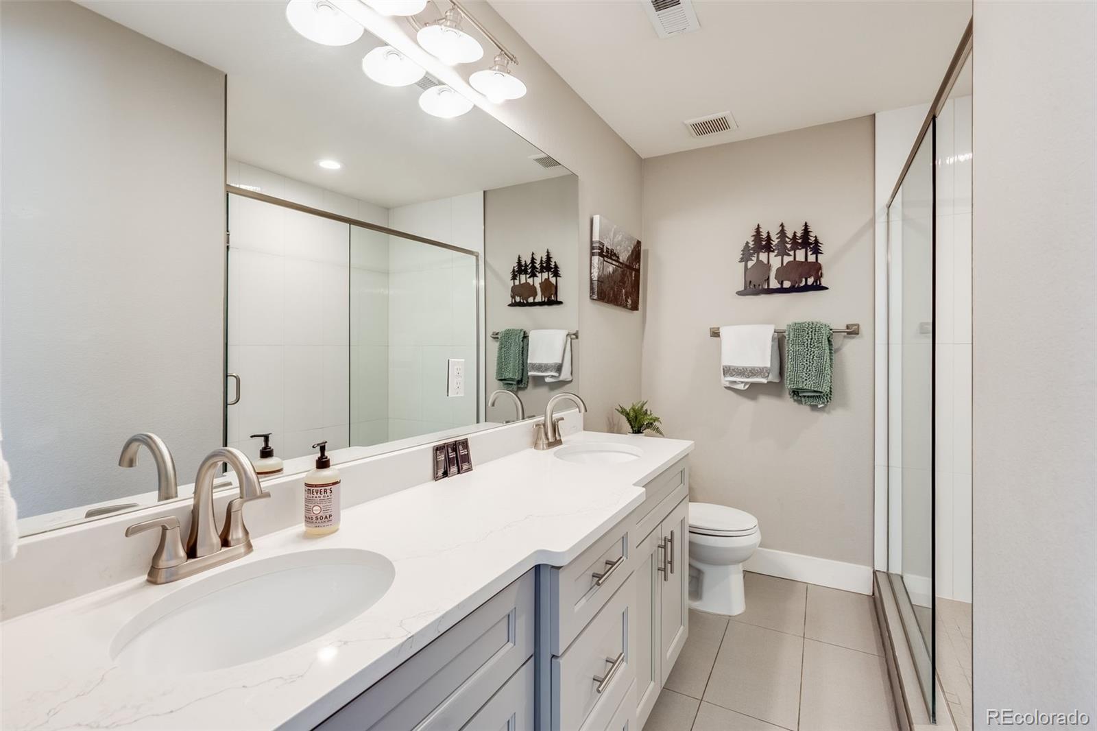 5240 Stuart Street Denver, CO 80212 - Photo 16 of 42 a bathroom with a sink and a mirror