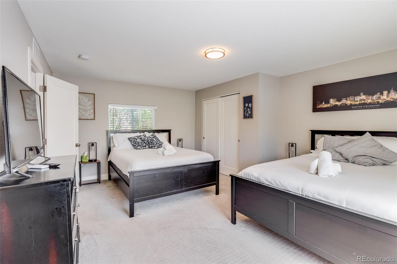 5240 Stuart Street Denver, CO 80212 - Photo 18 of 42 a bedroom with a bed and window