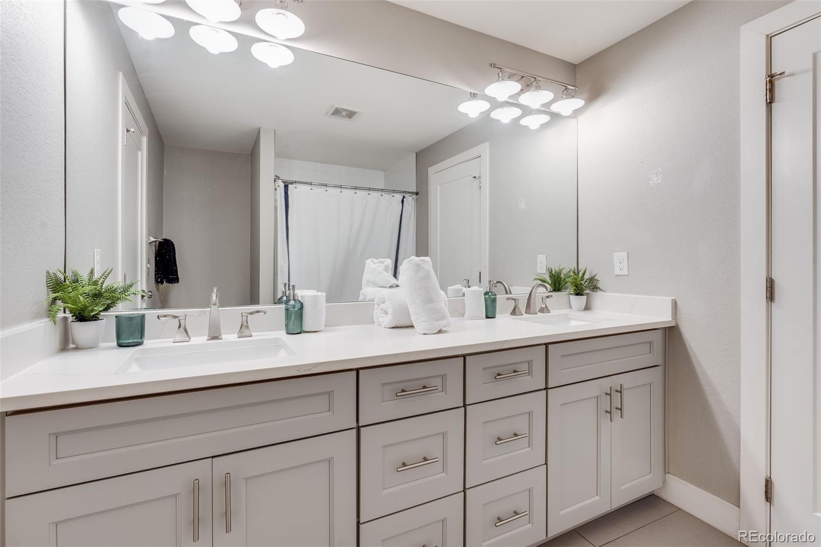 5240 Stuart Street Denver, CO 80212 - Photo 20 of 42 a bathroom with a sink double vanity and a mirror