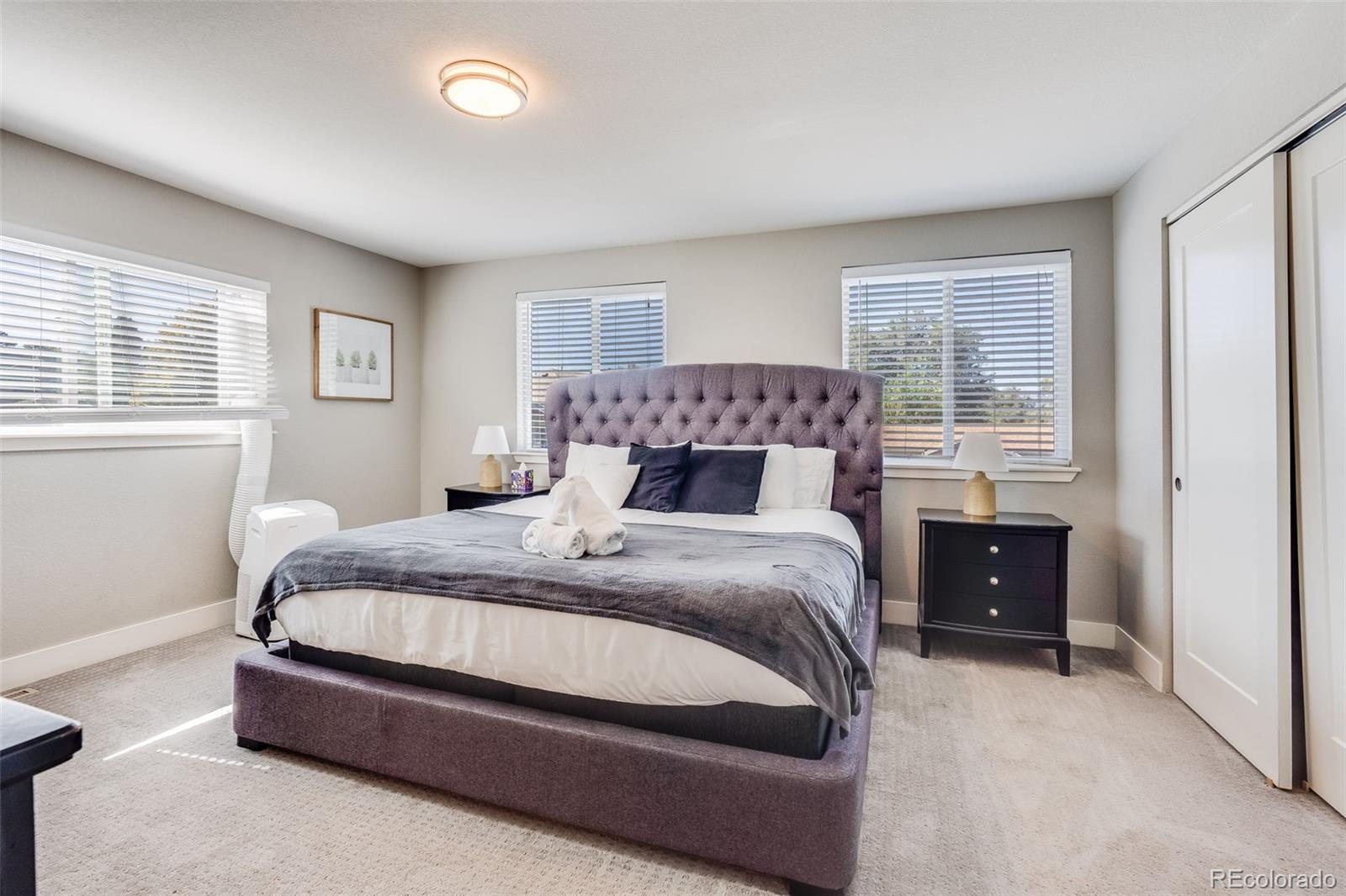 5240 Stuart Street Denver, CO 80212 - Photo 21 of 42 a bedroom with a large bed and a window