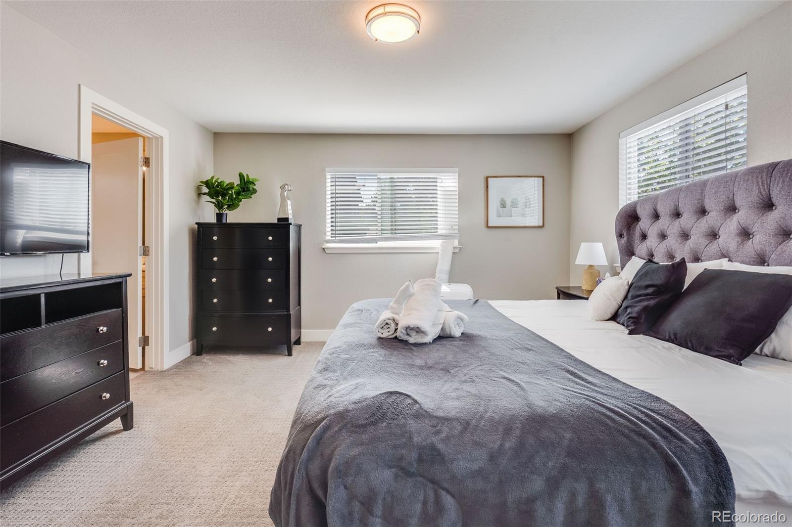 5240 Stuart Street Denver, CO 80212 - Photo 22 of 42 a bedroom with a bed and window